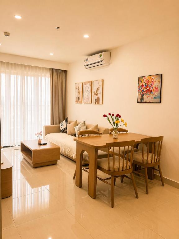 a living room with a couch and a table with a dining room at Nera Stay Huế - Luxury Apartment in Hue