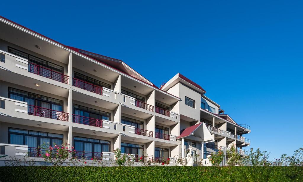 an apartment building with balconies and a blue sky at Revathi Resorts in Jajal