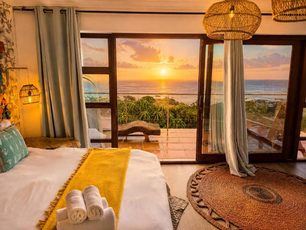 a bedroom with a bed with a view of the ocean at VistaBlu Camps Bay in Cape Town