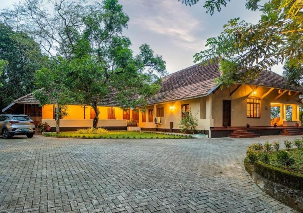 a house with a car parked in front of it at Villa Mariam in Cheruvalli