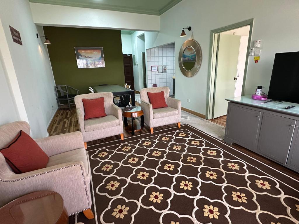 a living room with two chairs and a rug at The Regency PortDickson A1-6 in Port Dickson