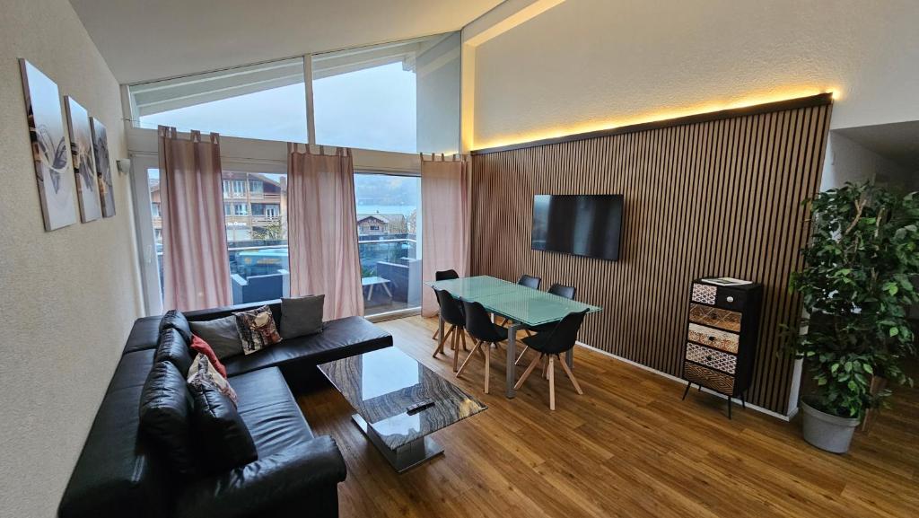 a living room with a couch and a table at SUITE in Brienz