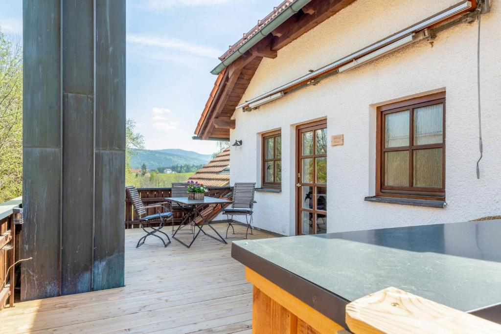 a patio with a table and chairs on a deck at Fewo Enzian in Breitenberg