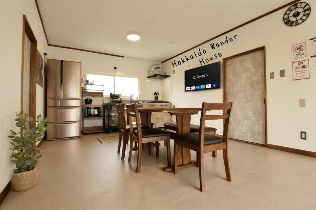 a kitchen and dining room with a table and chairs at Hokkaido Wander House in Ashibetsu