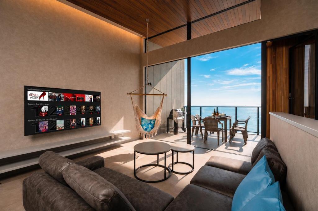 a living room with a couch and a view of the ocean at nagisa awajishima in Awaji