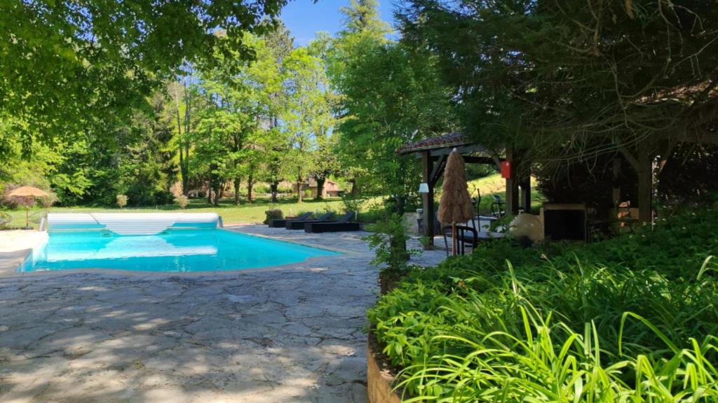 a swimming pool in a yard with trees and grass at Bonfarto Locations in Urval