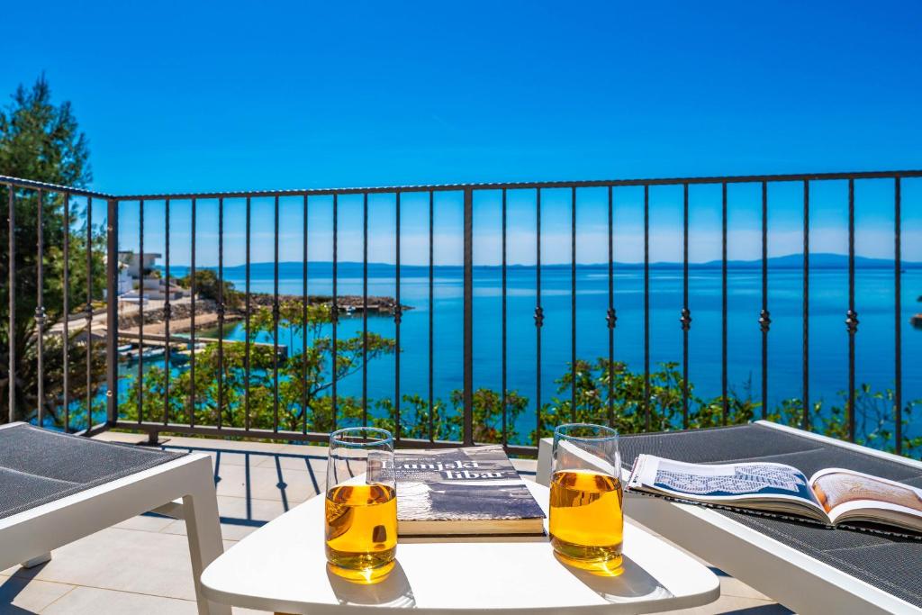 two glasses of beer on a table on a balcony at Angelina in Jakišnica