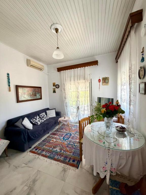 a living room with a table and a couch at Domi's Cottage in Agia Triada