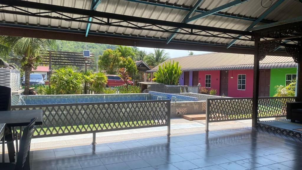 a view of a patio with benches and a building at Hotel O Green Desa Bayu in Kota