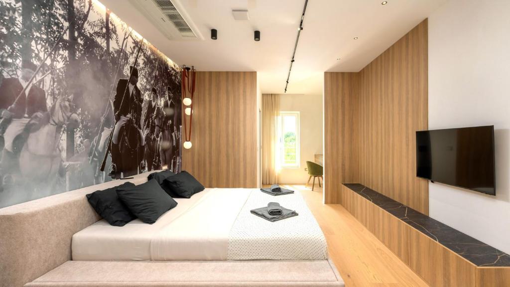 a bedroom with a bed and a flat screen tv at Villa Corsa by Villas Guide in Barban
