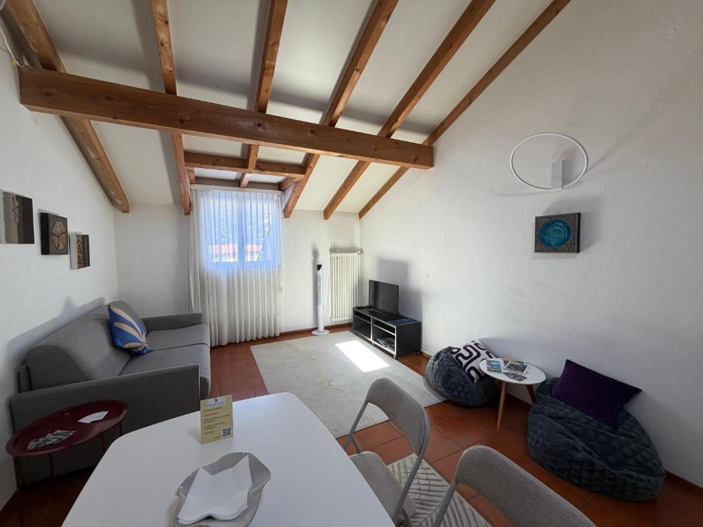 a living room with a couch and a table at Special apartment in Ascona in Ascona