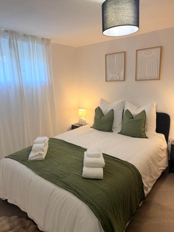 a bedroom with a large bed with towels on it at Lumière du paradis in Villes-sur-Auzon