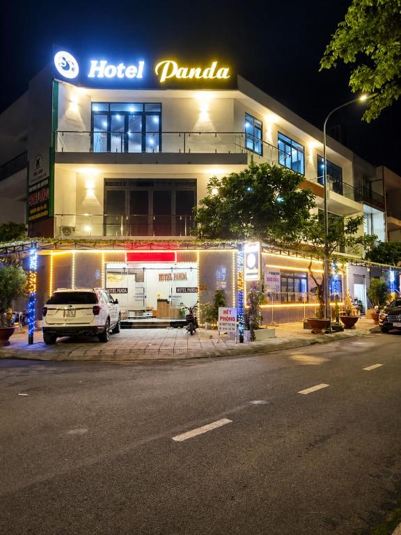 a hotel parking lot in front of a building at night at Panda Hotel in Long Thành