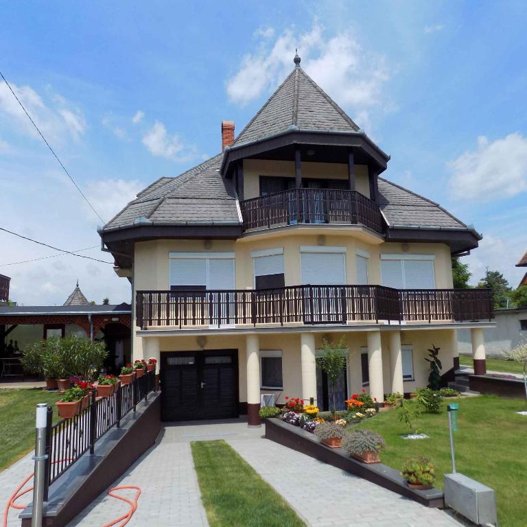 a large house with a gambrel roof at Apartment Gyenesdias 3 in Gyenesdiás