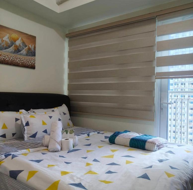 a bed with a stuffed animal on top of it at Condo unit open for staycation in Manila