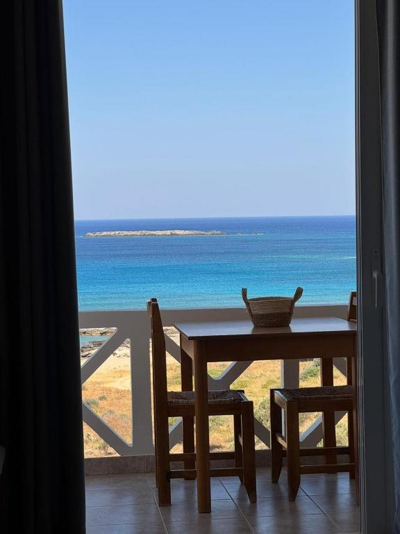 a table and chairs with a view of the ocean at Kofini Falassarna in Falasarna