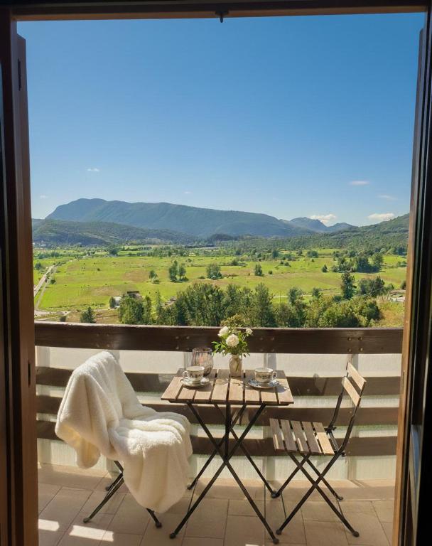 a table and chairs on a balcony with a view at Attico e super attico panoramico in Rocca di Cambio