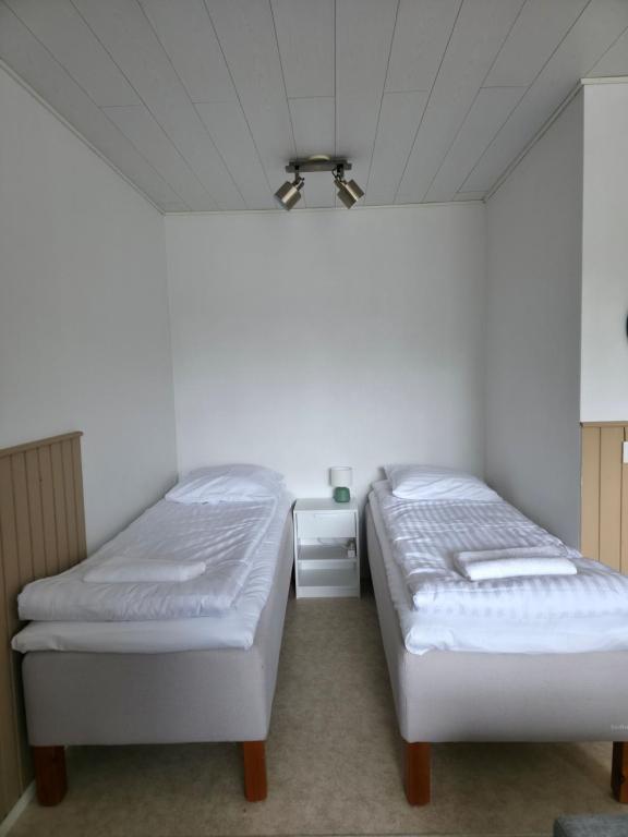 a bedroom with two beds and a ceiling at Kotoisa 1 in Seinäjoki
