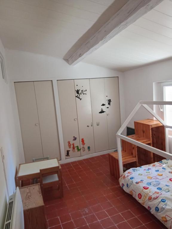 a bedroom with a bed and some cabinets at 3 la Placette in Varages
