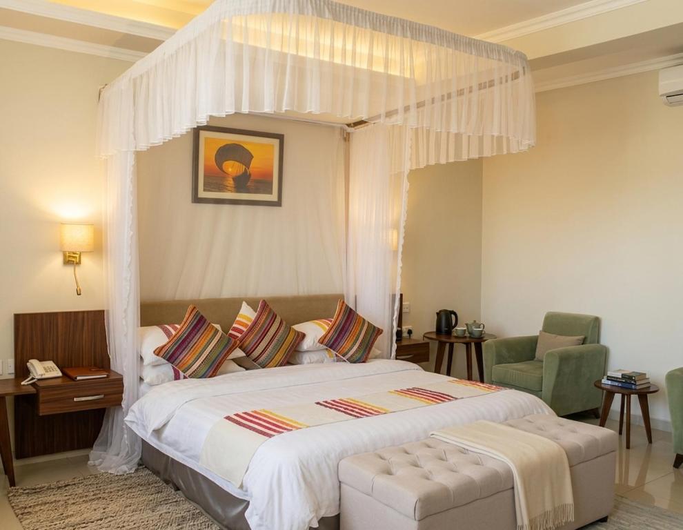 a bedroom with a large bed with a canopy at Rosewood by Amaryllis Lilongwe in Lilongwe