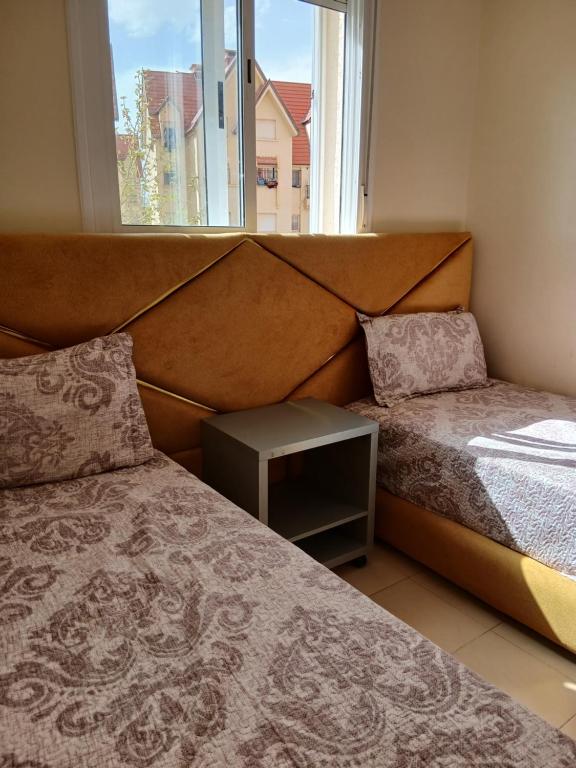 a bedroom with two beds and a window at Irini in Ifrane