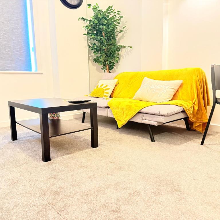 a living room with a couch and a coffee table at The Forgate exchange in Worcester