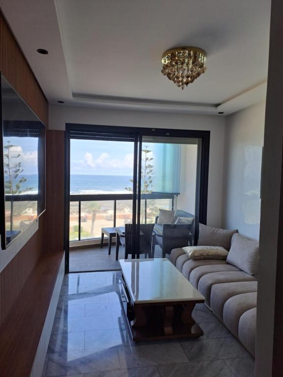 a living room with a couch and a table at Blue Horizon Mansouriah in Mohammedia