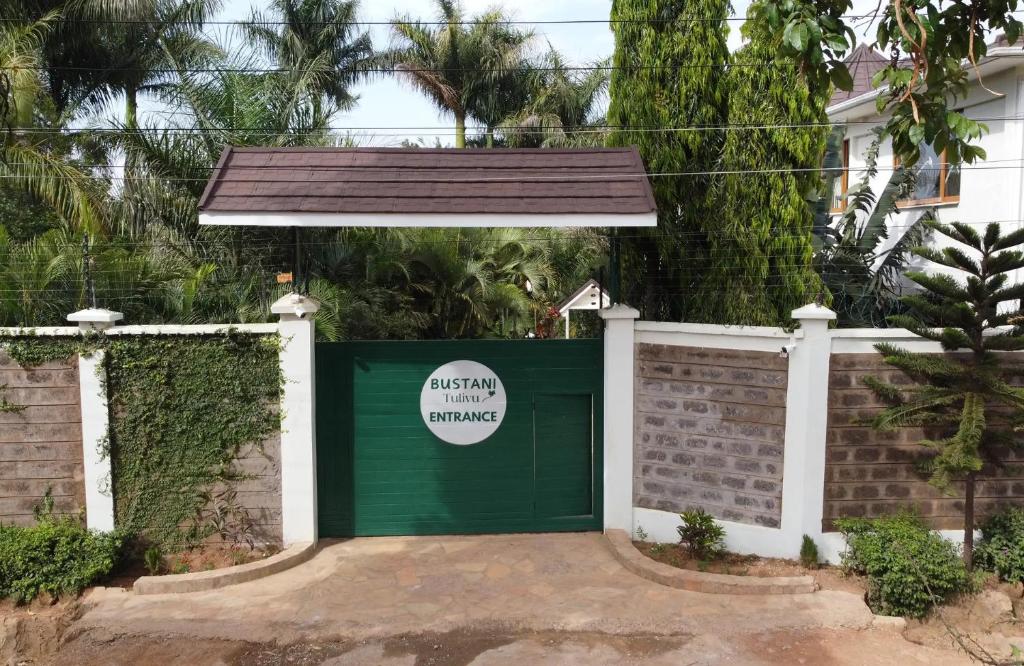 a green garage door with a sign on it at Bustani Tulivu in Bungoma