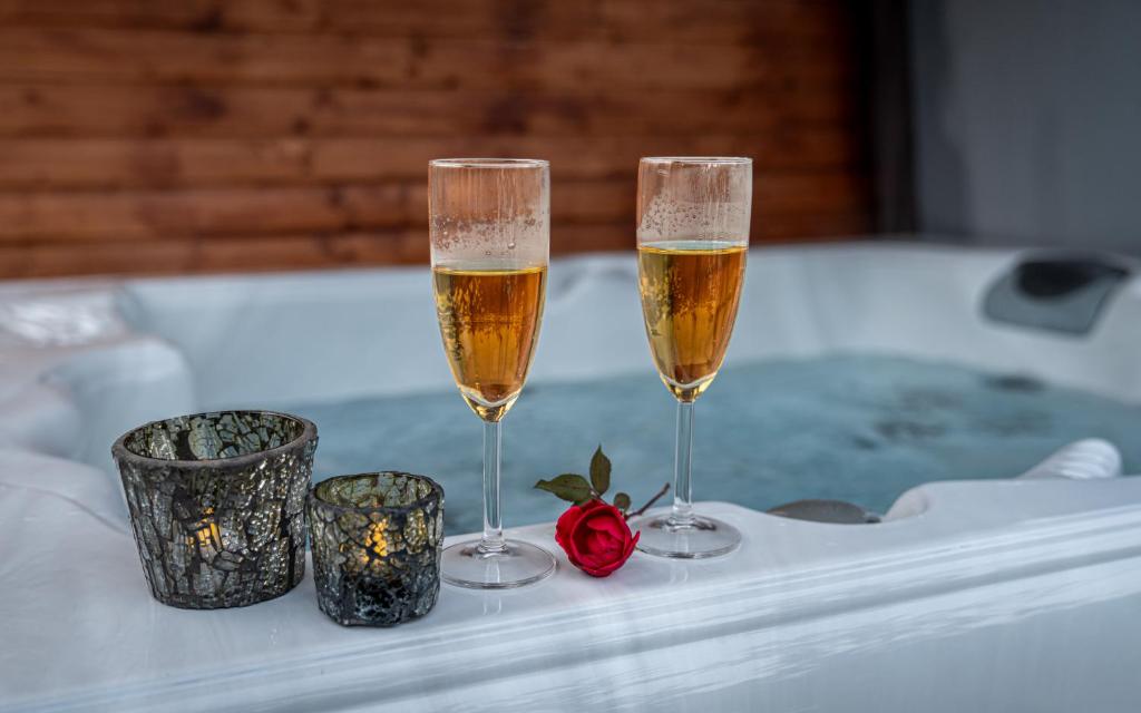 two glasses of champagne sitting on a table at Sukorose Jacuzzis Vendégház in Sukoró