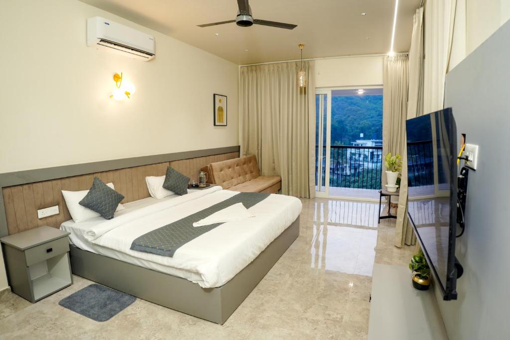 a bedroom with a bed and a balcony at Gems Munnar in Anachal