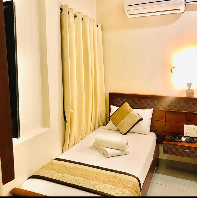 a bed with two pillows on it in a room at ROYAL RESIDENCY Ac in Virudunagar