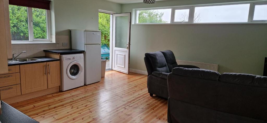 a living room with a couch and a kitchen at Claddagh in Galway