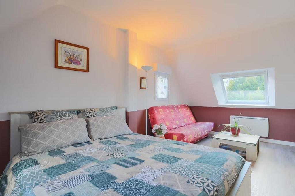 a bedroom with a bed and a couch at Chambres D'hôtes Soizic in Paimpol