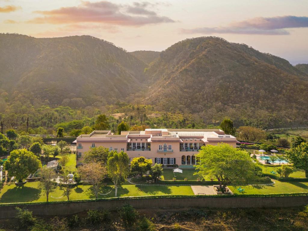an aerial view of a building with mountains in the background at Ramgarh Lodge, Jaipur – IHCL SeleQtions in Jaipur