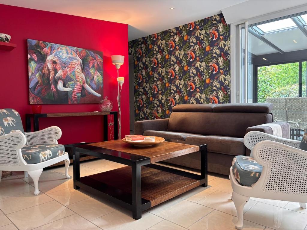 a living room with a couch and a table at La Maison des Eléphants in Vivonne