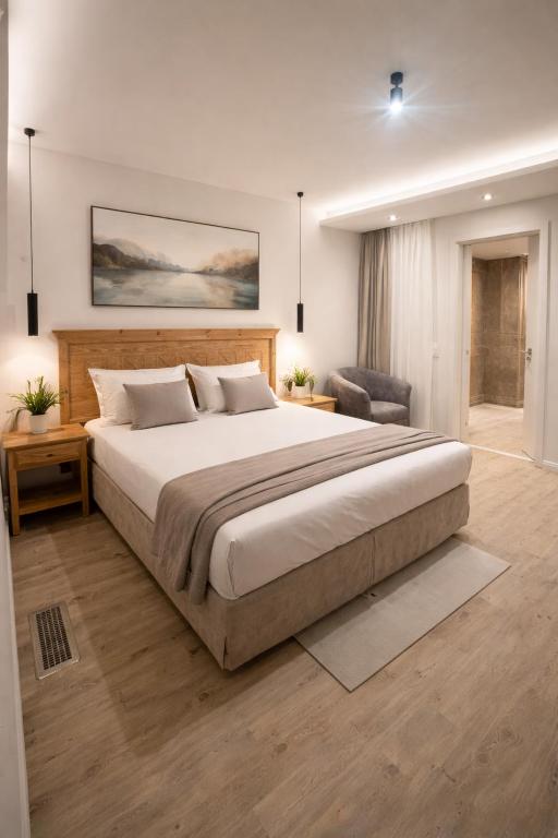 a bedroom with a large bed and a chair at Hotel Night4Flight Hamburg-Airport in Hamburg
