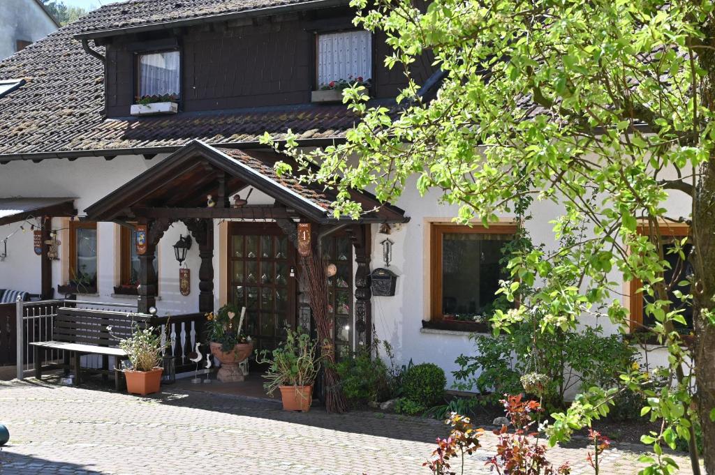 a house with a bench in front of it at Pension Schöpke in Bad Staffelstein