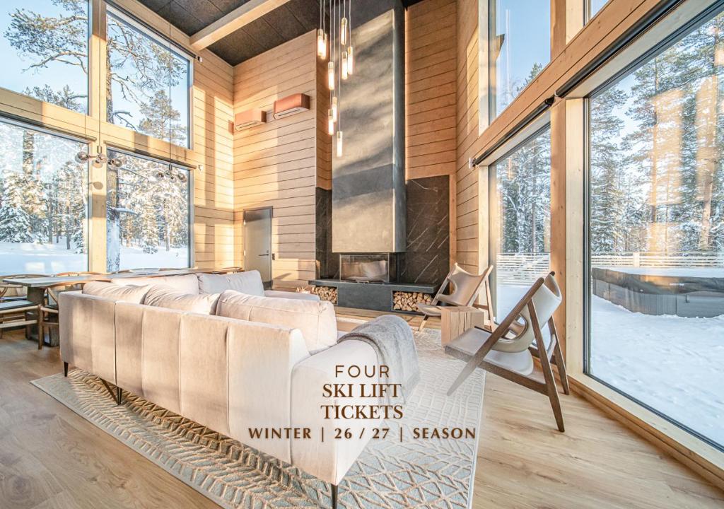 a living room with a couch and a fireplace at Kaira Chalet Ylläs by Aavalevi in Ylläsjärvi
