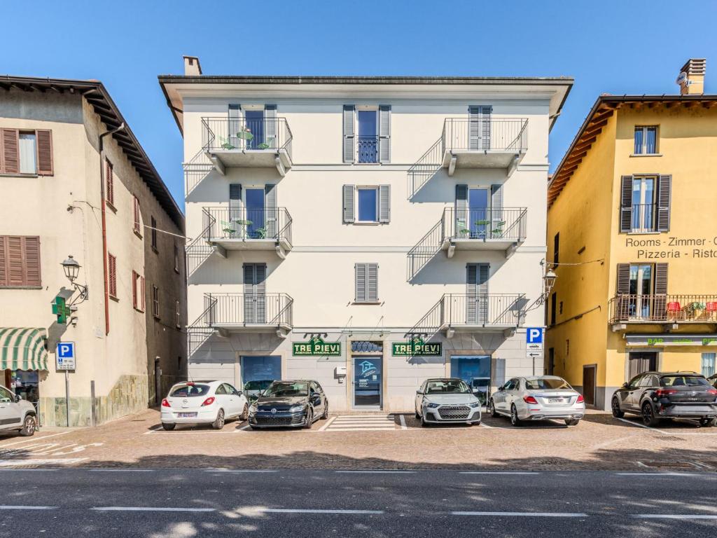 a building with cars parked in a parking lot at Apartment Tinca by Interhome in Domaso