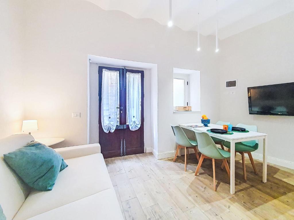 a living room with a white couch and a table at Apartment Studio Kalè Akté by Interhome in Caronia