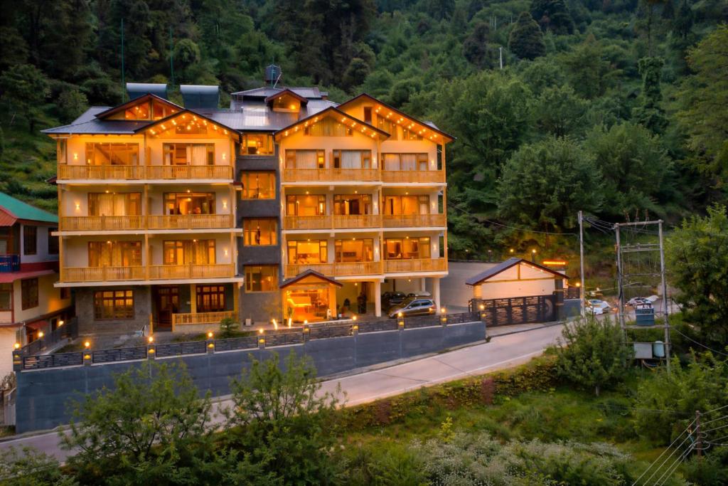 a large building with lights on the side of a road at Regal Retreat Inn in Shirir
