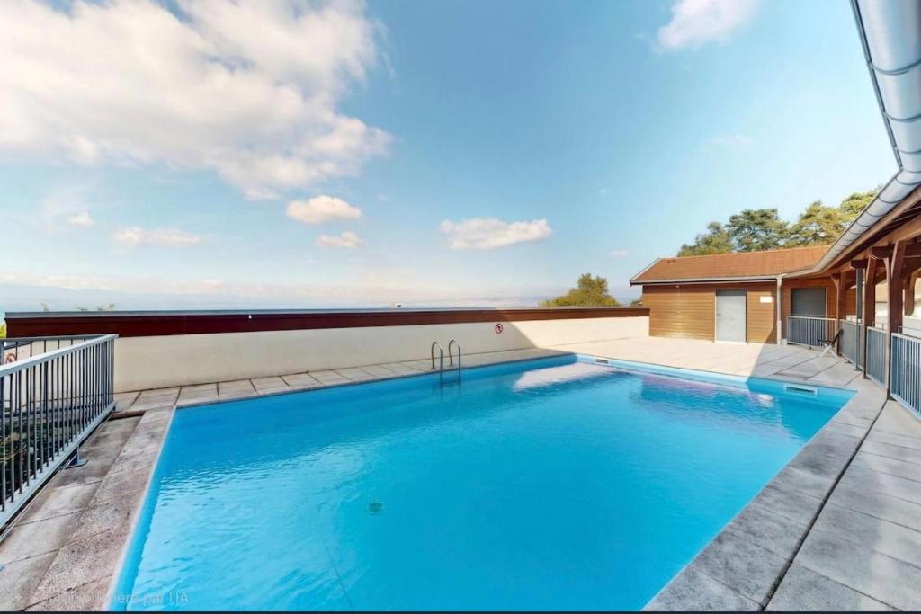 a swimming pool on the roof of a house at Appartement T2 lac Léman in Publier