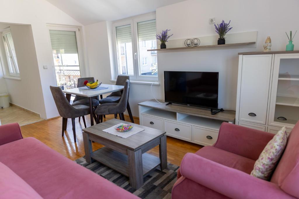 a living room with a couch and a tv at Banja Koviljača Apartmani Matić in Banja Koviljača