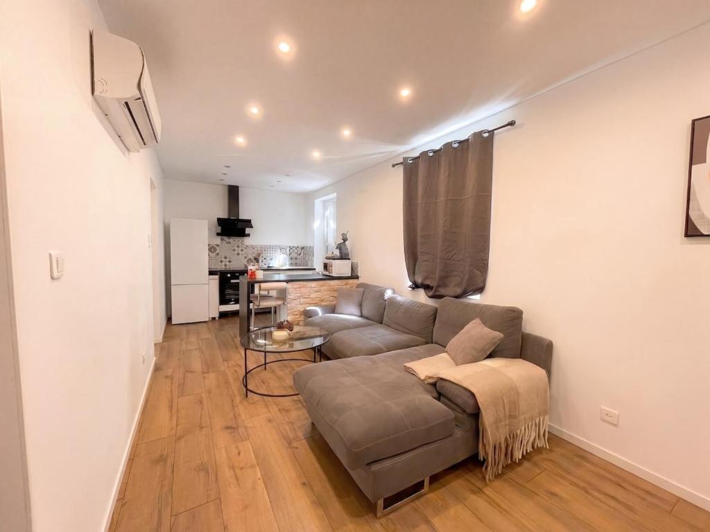 a living room with a couch and a table at L'Écrin Beige - Moderne - Portes de Strasbourg in Schiltigheim