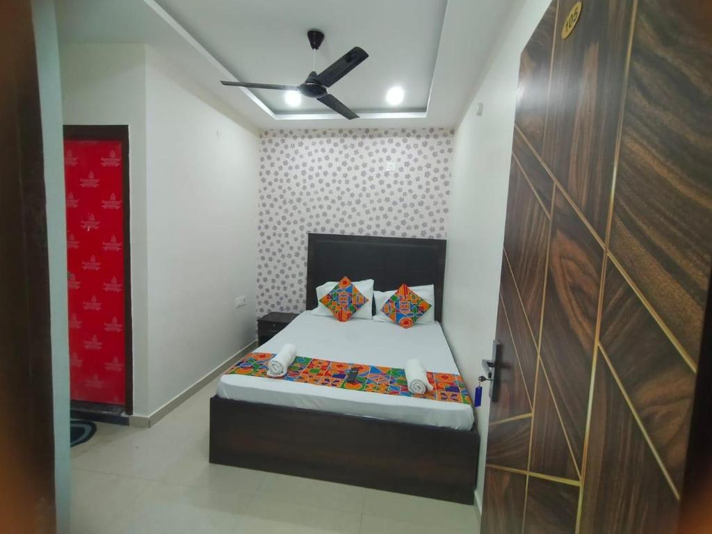 a bedroom with a bed and a ceiling fan at HOTEL TIRUMALA VAIBHAv in Secunderabad