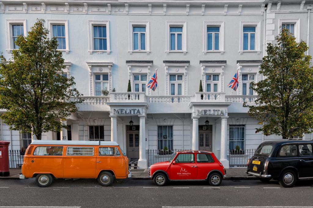 two cars parked in front of a white building at The Melita in London