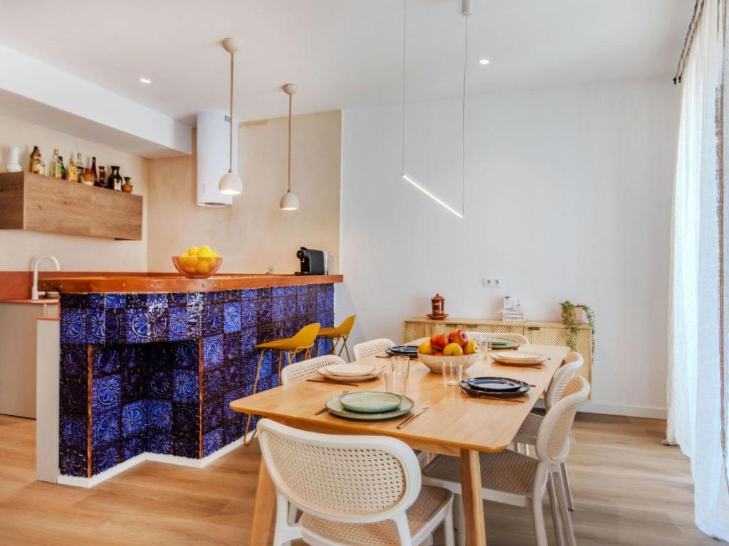 a kitchen and dining room with a wooden table and chairs at Apartment Edificio Candela-1 by Interhome in L'Ametlla de Mar