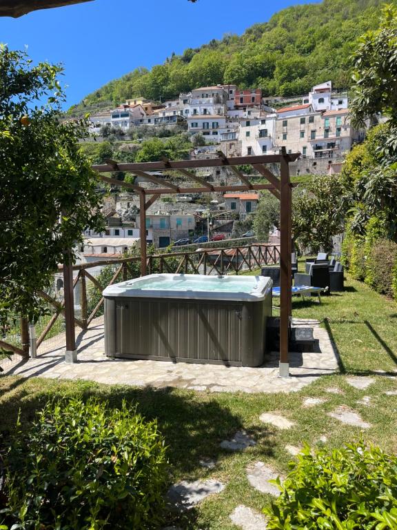 a hot tub in a yard with a city at Villa la Torretta in Scala