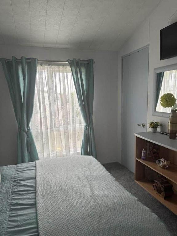 a bedroom with a bed and a large window at Jude 615 in Barmouth