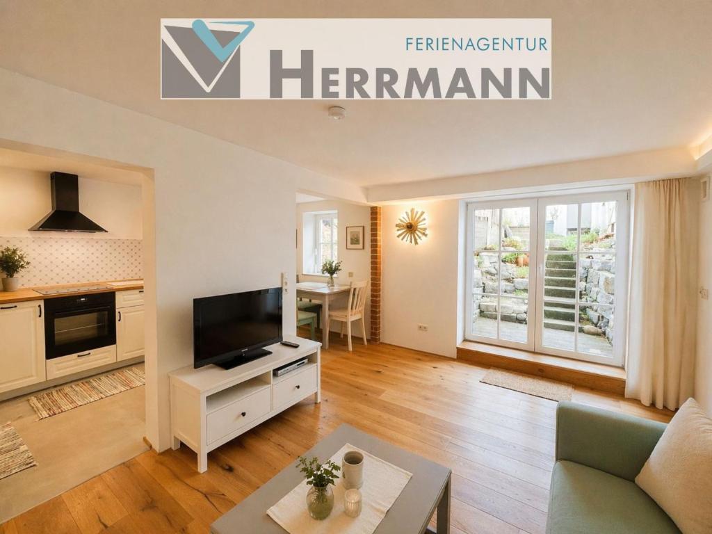 a living room with a television and a table at Finca Ludwig am Forggensee in Rieden